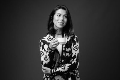 Portrait of young woman drinking coffee