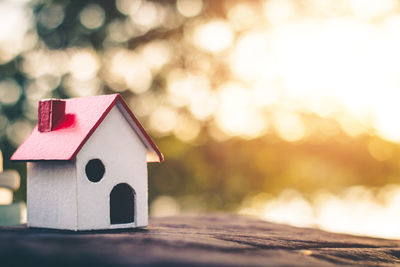 Close-up of toy on wood against building