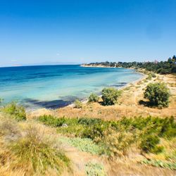 Scenic view of sea against clear blue sky