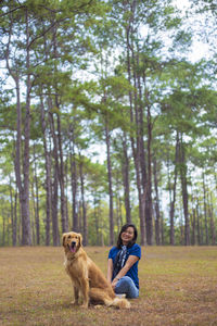Full length of man with dog in forest