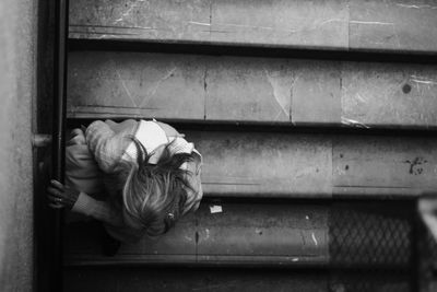 High angle view of homeless woman sitting on steps