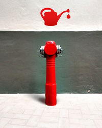 Red fire hydrant on wall