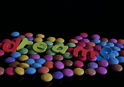 High angle view of multi colored balloons against black background