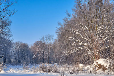 Snow covered field against clear sky