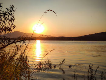 Scenic view of lake against sky during sunset