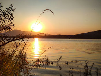 Scenic view of lake against sky during sunset