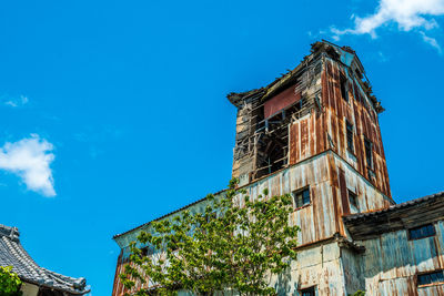 Low angle view of building against blue sky