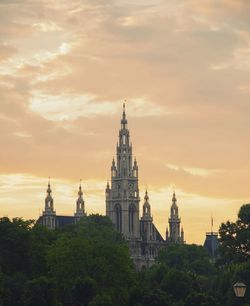 View of city lit up at sunset