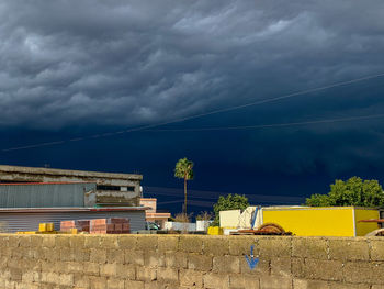 Buildings against cloudy sky