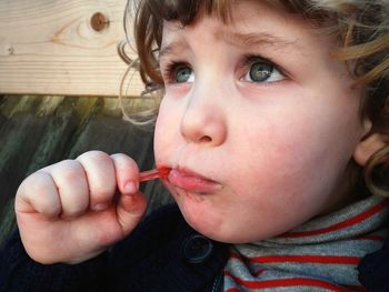 Close-up portrait of cute boy eating food
