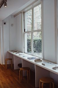 Empty chairs and table by window at home