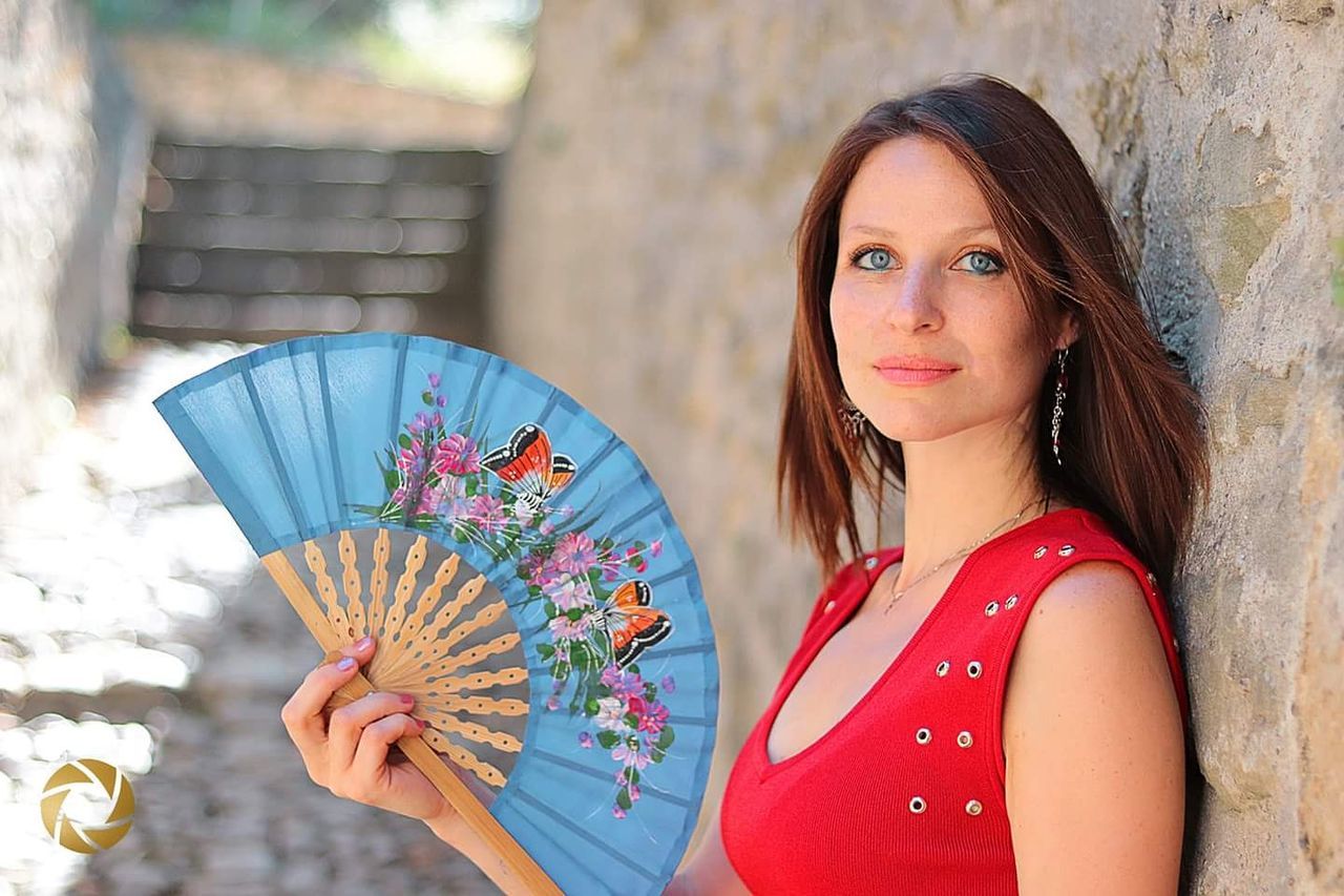 one person, portrait, young adult, young women, lifestyles, women, long hair, holding, adult, looking at camera, leisure activity, focus on foreground, real people, day, beauty, hairstyle, headshot, front view, outdoors, beautiful woman, floral pattern, contemplation