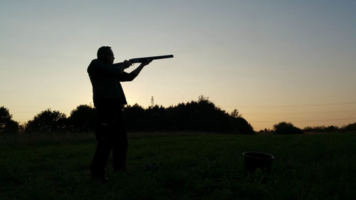 Silhouette of man standing on golf course