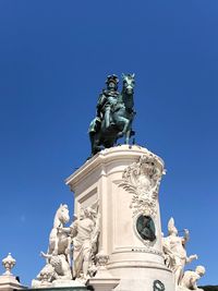 Low angle view of statue against blue sky