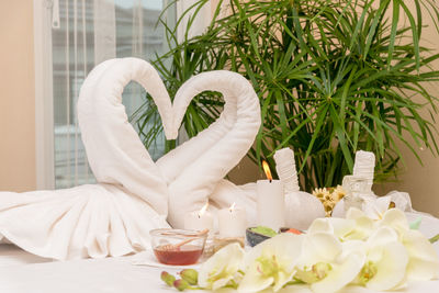 Heart shape towels on bed at spa in luxury hotel