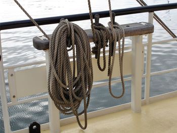 Sailboat tied to railing against sea