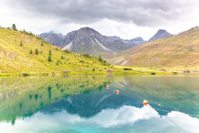 Lake of tignes surrounded by the peaks of the vanoise in haute tarentaise under a stormy  sky