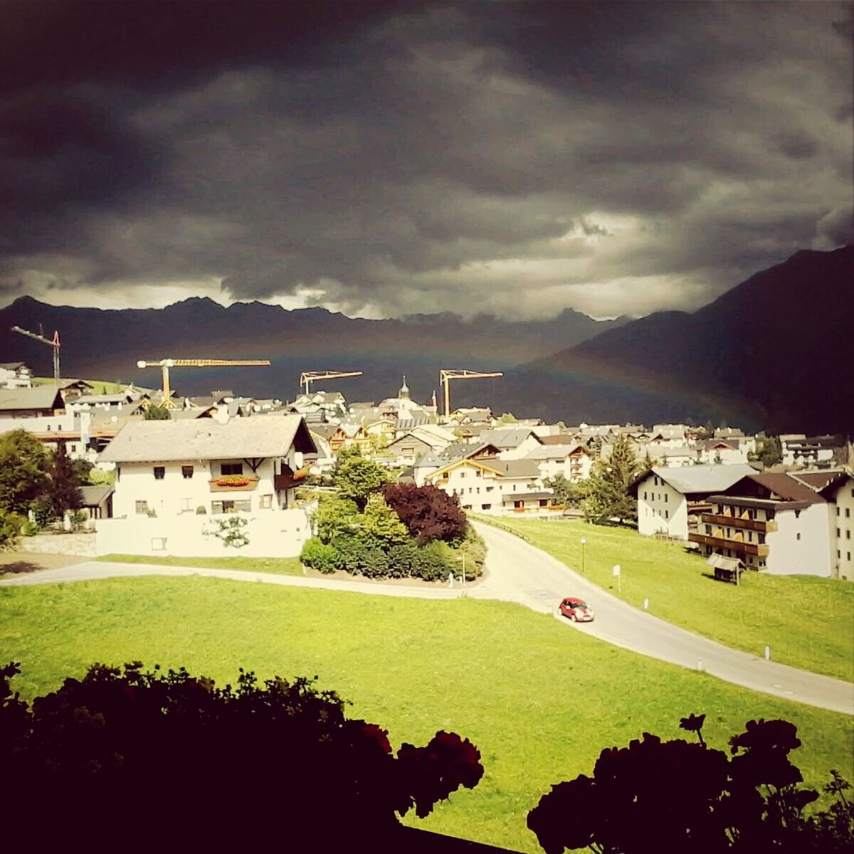 building exterior, architecture, sky, built structure, cloud - sky, house, mountain, water, cloudy, sea, residential structure, residential building, tree, cloud, town, plant, nature, high angle view, mountain range, outdoors