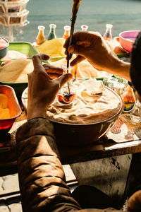 Low section of man preparing food on table