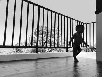 Full length of woman standing on railing