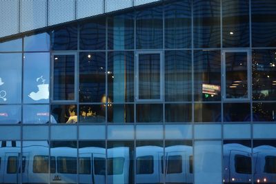 Reflection of building on glass window at night