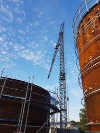 Low angle view of crane against sky