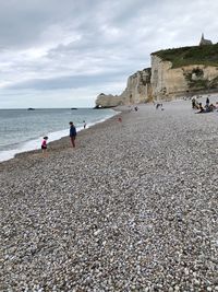 People on beach against sky