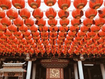 Low angle view of lanterns hanging by building