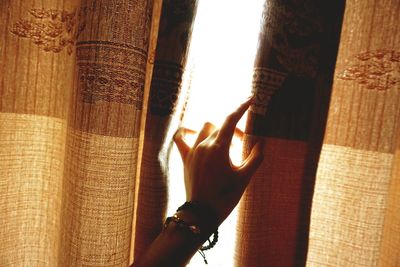 Close-up of a hand at the window