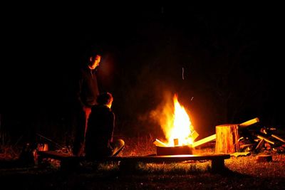 Man burning fire at night