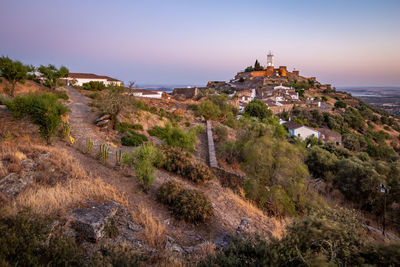 Scenic view of sea and buildings against sky