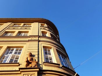 Low angle view of building against clear blue sky