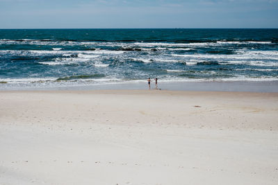 Scenic view of beach against blue sky