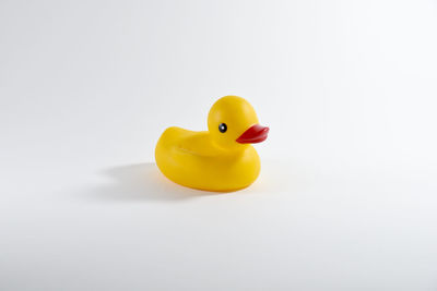 Close-up of yellow toy over white background