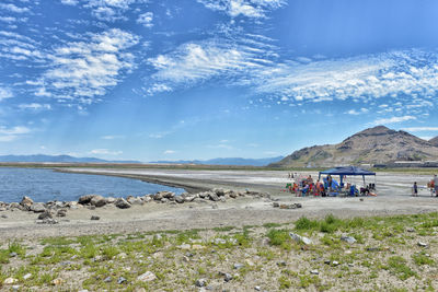 Group of people on rock against sky