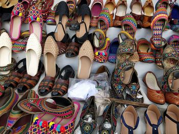 Multi colored shoes for sale at market stall
