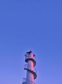 Low angle view of lighthouse against blue sky