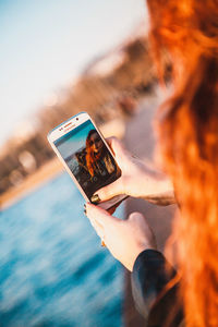 Midsection of man using mobile phone