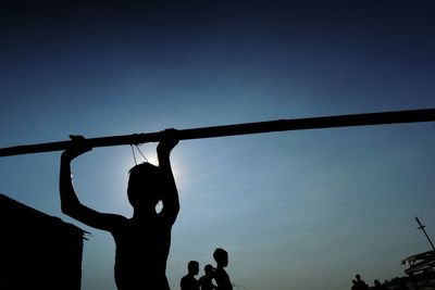 Silhouette children against clear sky