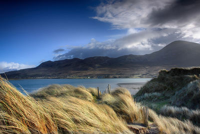 Scenic view of mountains against blue sky