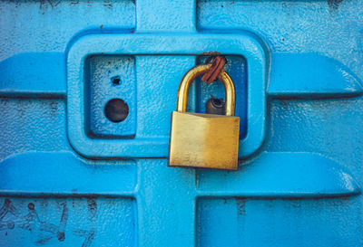 Close-up of padlock on blue door