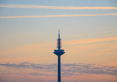 Low angle view of tower against cloudy sky