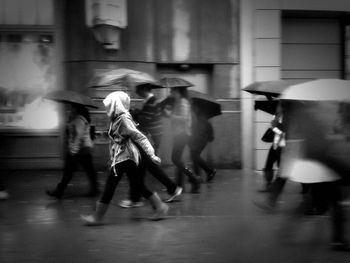 People walking on street during monsoon