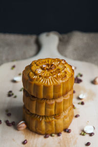 Close-up of moon cakes with seeds arranged on cutting board