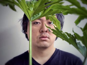 Portrait of young man against plants