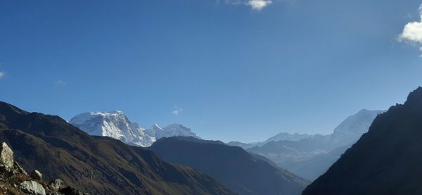 Scenic view of snowcapped mountains against clear blue sky