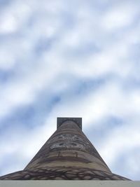 Low angle view of building against cloudy sky