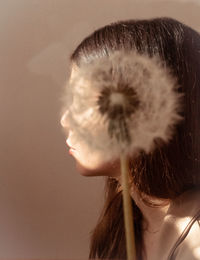 Close-up portrait of a young woman looking away