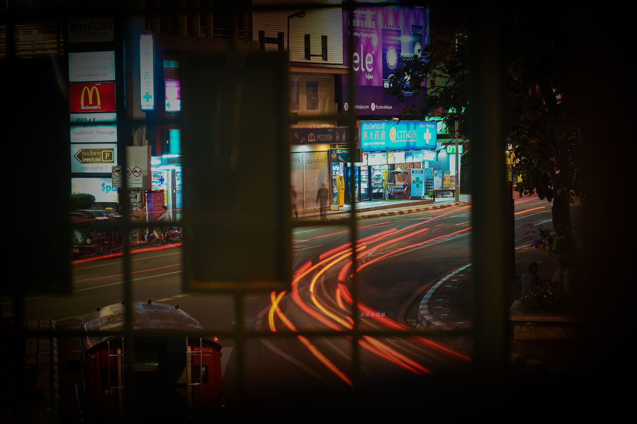 LIGHT TRAILS ON ROAD AT NIGHT