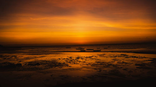 Scenic view of sea against romantic sky at sunset